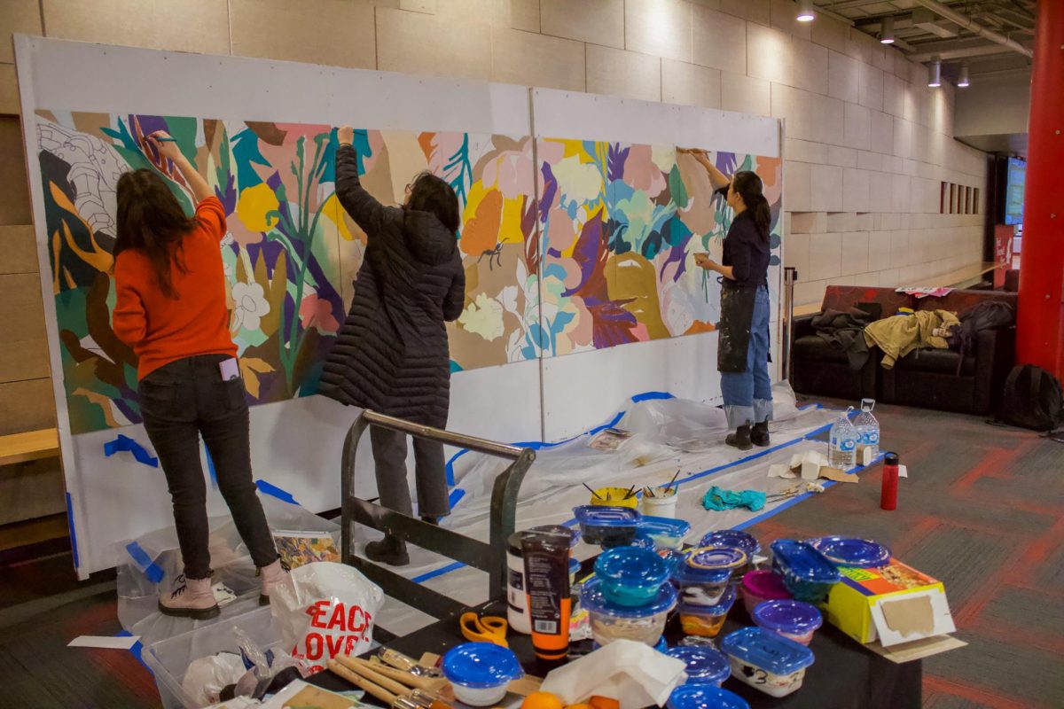 Students working on the new Healing wall mural in the Compton Union Building.