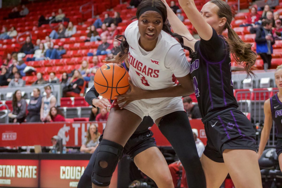 Center Candace Kpetikou posts up against a Portland defender on Jan. 23 in Pullman, Wash.