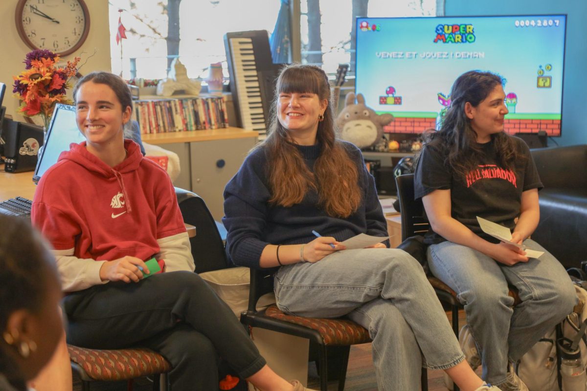 Tennis player Martina Puvill and women's basketball player Marta Alsina listen in a discussion with other students at the International center on Feb. 28.