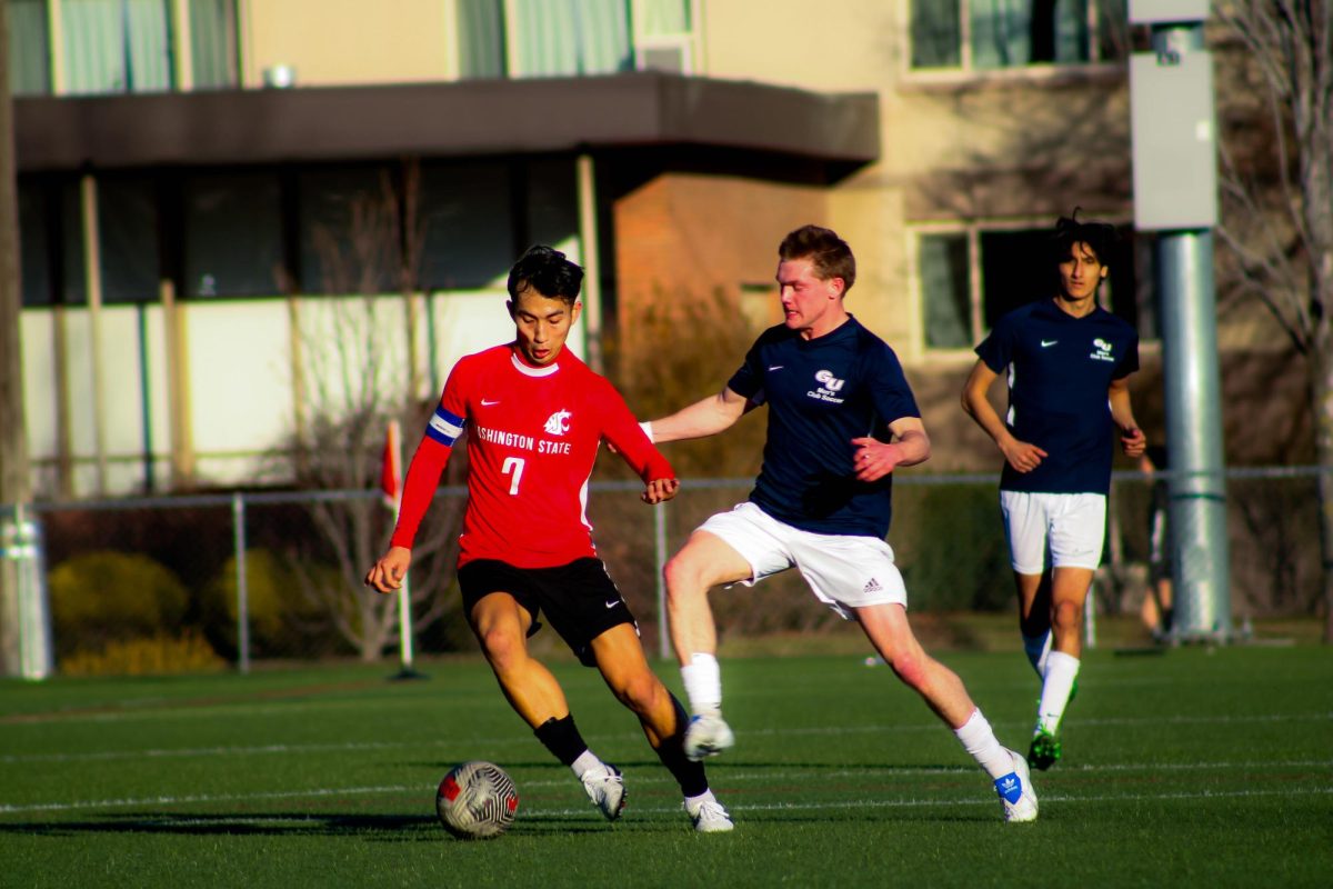 Men's soccer club captain Kento Ichimura fends off a Gonzaga defender on March 1, in Spokane, Wash.