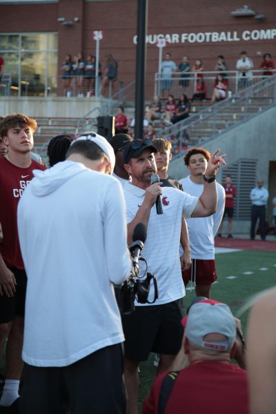 Football head coach Jimmy Rogers speaks to the crowd at a pep rally on Aug. 13 in Martin Stadium.