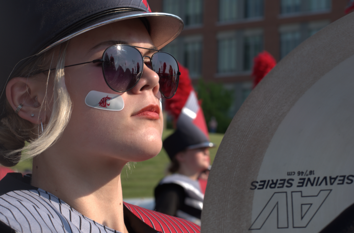 A Cougar Marching Band member plays the cymbals during a parade before the football game Aug. 20, 2025.