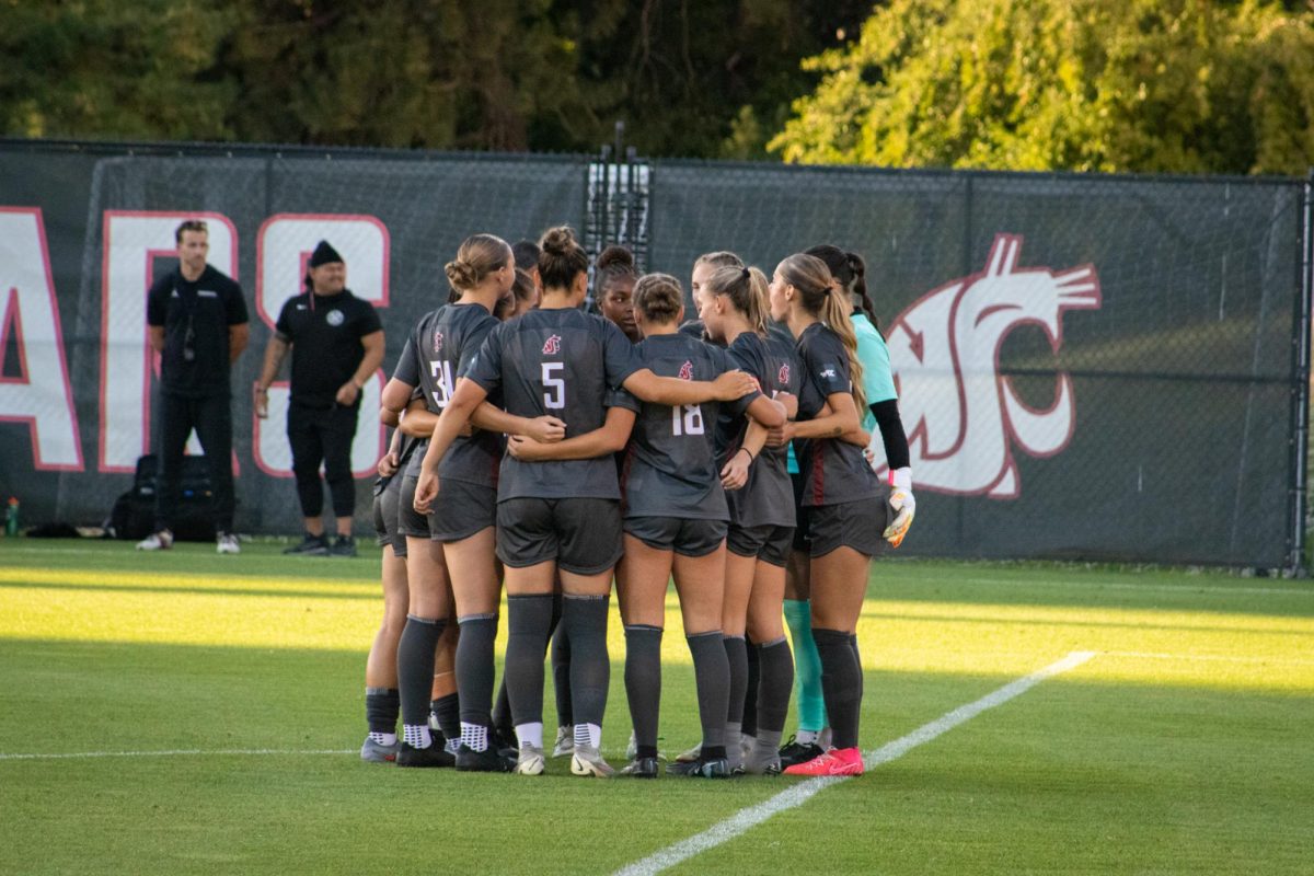 The WSU Cougar soccer starting lineup huddles up before their match against Utah State on Aug. 14 in Pullman, Wash.