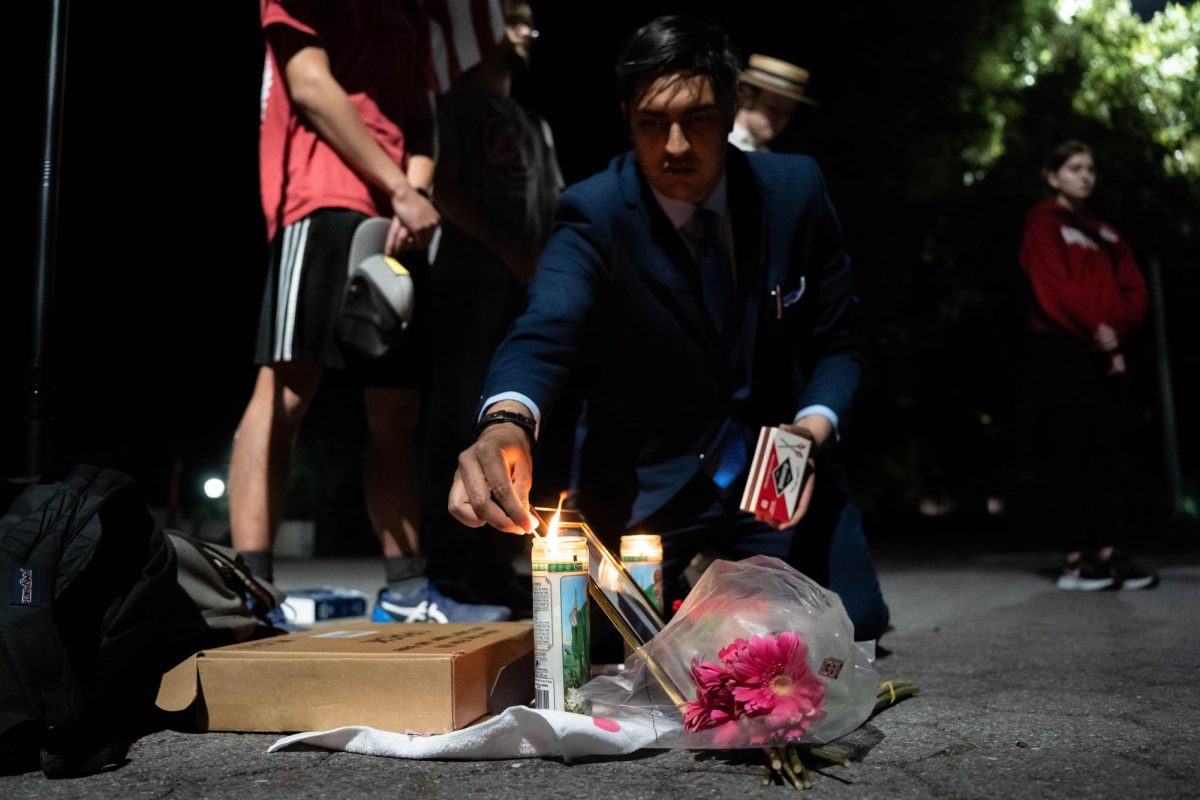 Student Jay Sani lights a candle during a vigil organized by Washington State University Republicans honoring the life of conservative activist Charlie Kirk, who was assassinated earlier in the day while speaking in Utah, on Wednesday, Sept. 10.