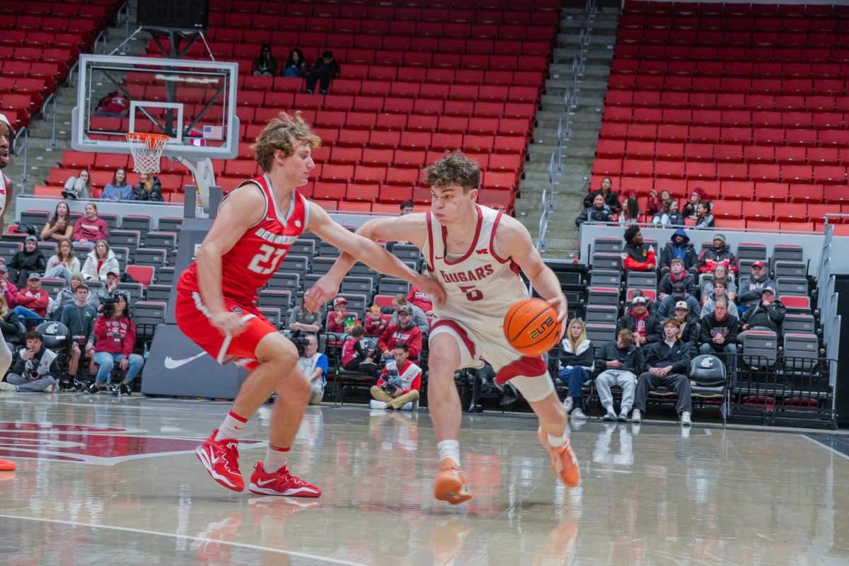 WSU Guard Tomas Thrastarson taking the ball up against New Mexico Guard Jake Hall, Oct. 25.
