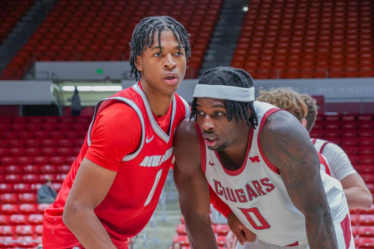 New Mexico Guard Kevin Patton Jr. blocking WSU Forward Emmanuel Ugbo as he waits for a pass, Oct. 25
