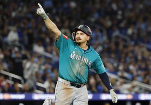 Seattle Mariners first baseman Josh Naylor (12) with his hand in the air as he rounds the bases on a two-run home run against the Toronto Blue Jays in Game 2 of the American League Championship Series Monday, Oct. 13, 2025, at Rogers Centre in Toronto. (Jennifer Buchanan/The Seattle Times/TNS)