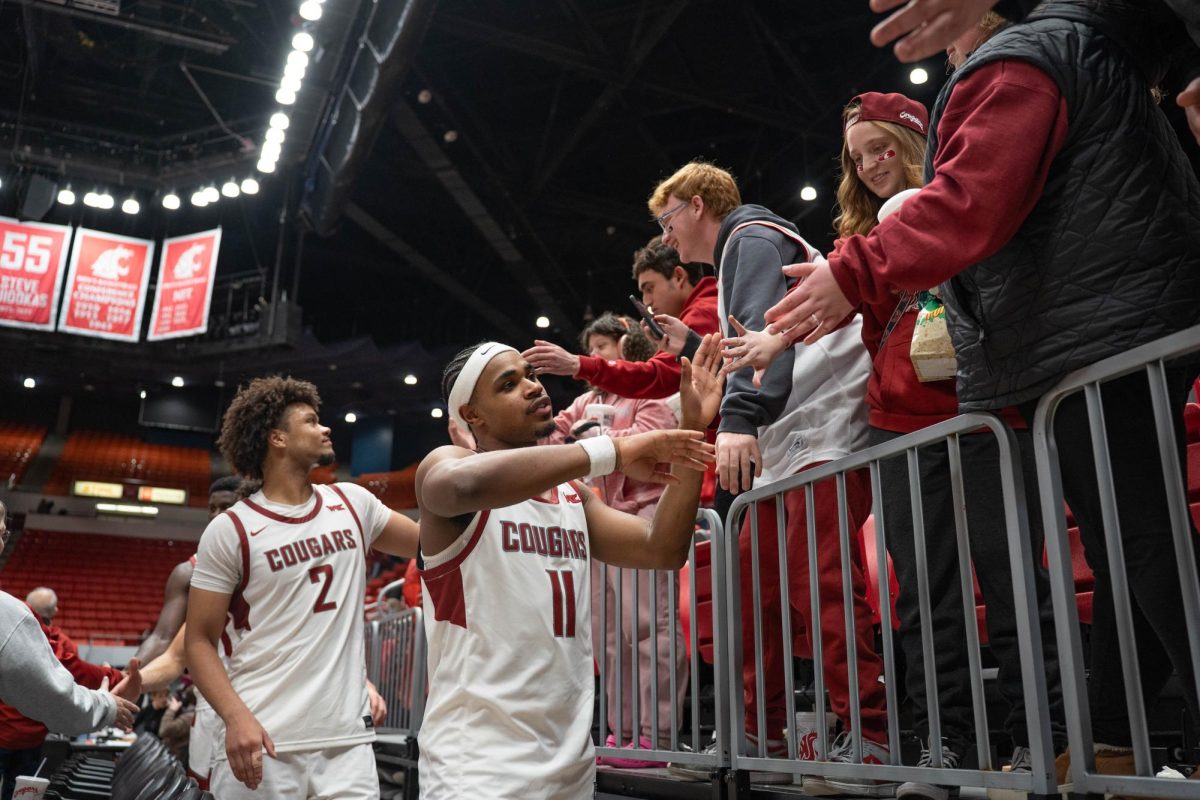 Washington State Guard Jerone Morton high fives fans after the Cougars' win over Southern Utah on Wednesday, Nov. 19 at Beasley Colosseum. 