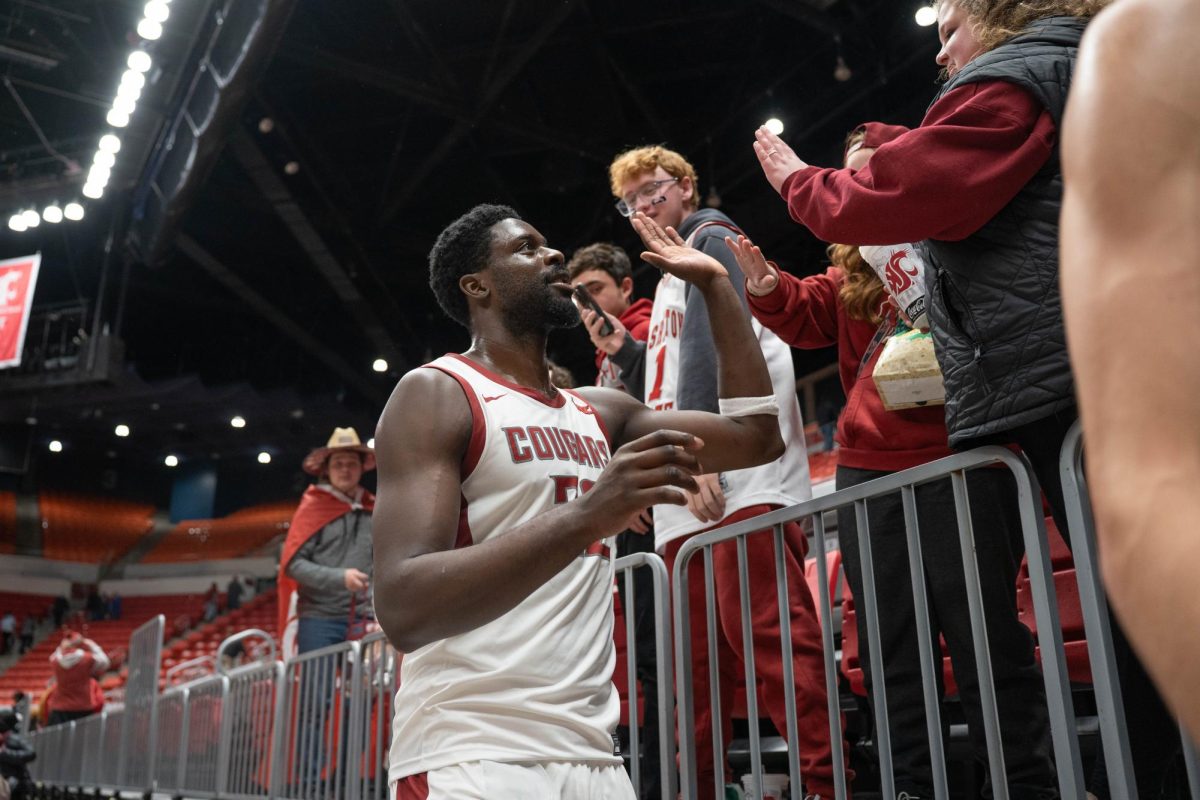 Washington State Forward ND Oakfor high fives fans while leaving the court after the Cougars' win over Southern Utah on Wednesday, Nov. 19 at Beasley Colosseum. 