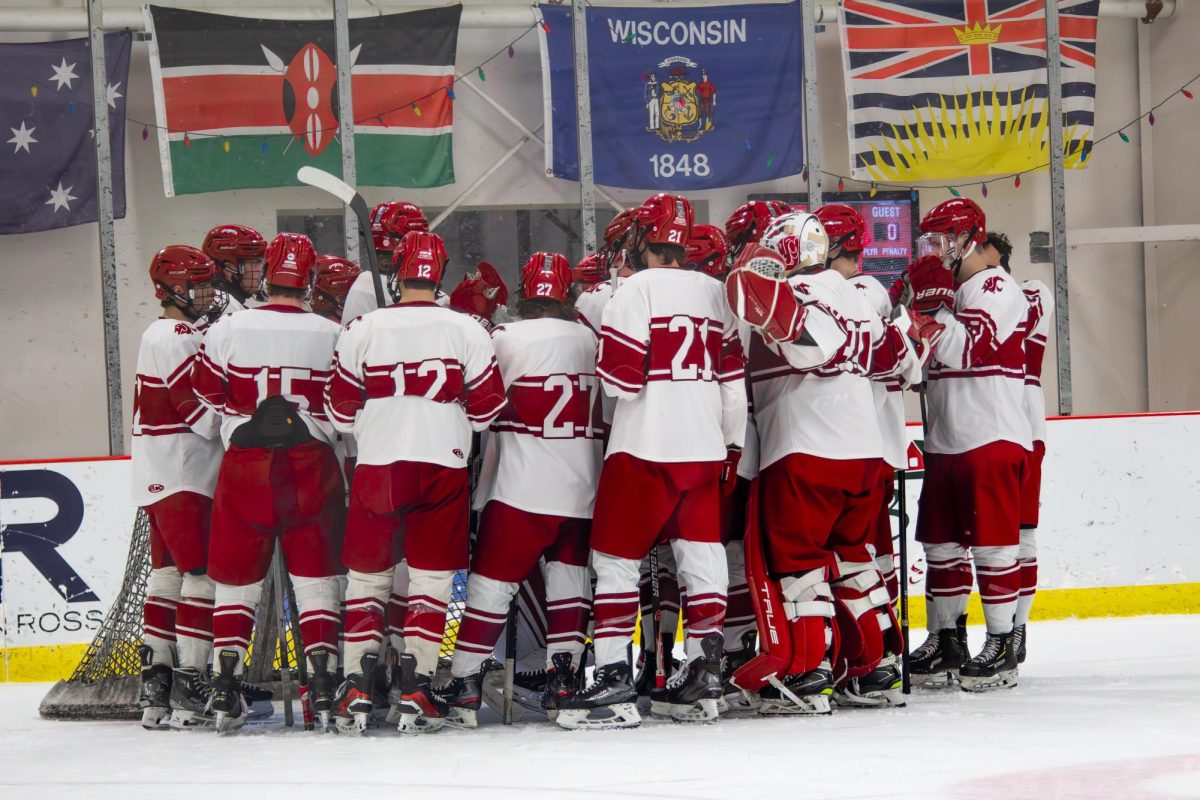 The WSU hockey team gathers around the net before a game against the University of Idaho on Nov. 15 2025. 