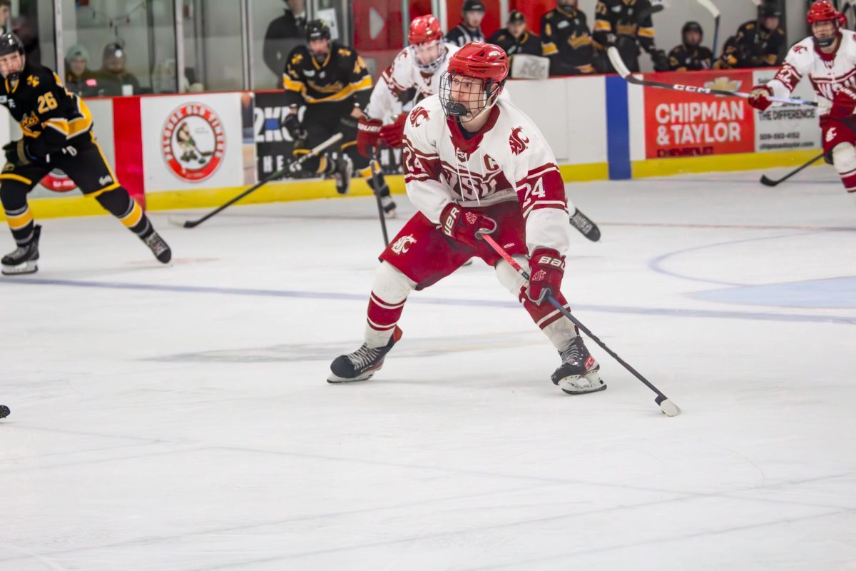 Cole Carlson skates the puck up ice for the WSU hockey team on Nov. 15 2025 against the University of Idaho. 