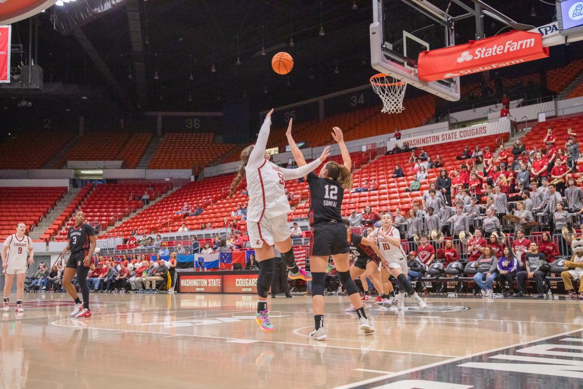 WSU Forward Malia Ruud makes a shot against a blocking Stanford Forward Lara Somfai, Nov. 14, 2025
