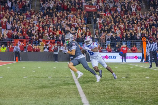 WSU cornerback David Kuku runs towards the end zone chased by LA Tech wide receiver Tre Averhart, Nov. 15, 2025.