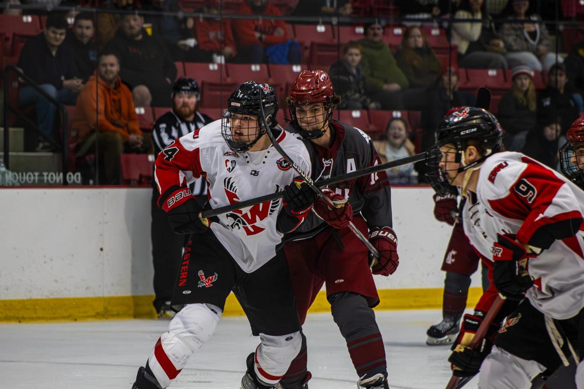 Senior forward Van Rayner battles with Sterling Myers on the Eastern Washington hockey team on Dec. 6 2025. 