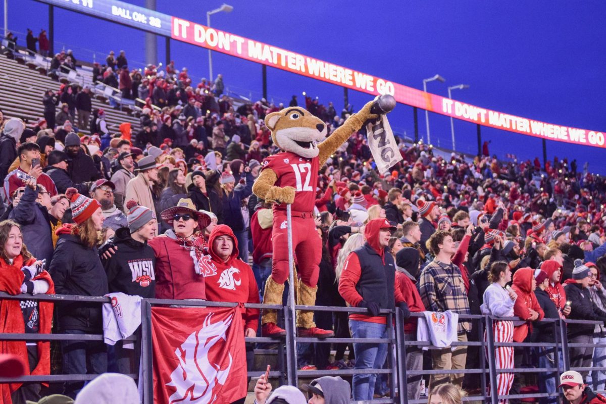 Butch T. Coug leading Wazzu football fans in a song during the game against OSU, Nov. 29, 2025