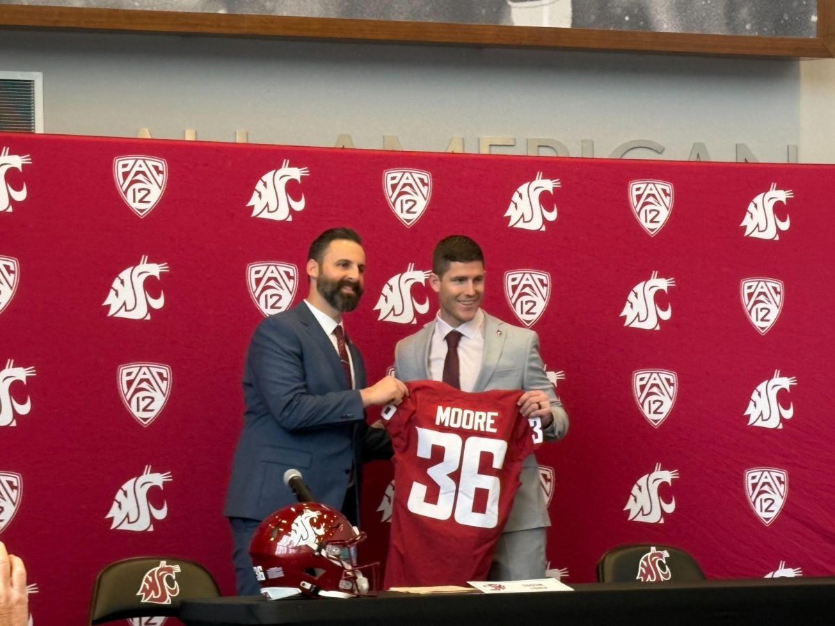 Interim Athletic Director Jon Haarlow (L) introduces new football coach Kirby Moore (R) on Dec. 17, 2025, at Martin Stadium.