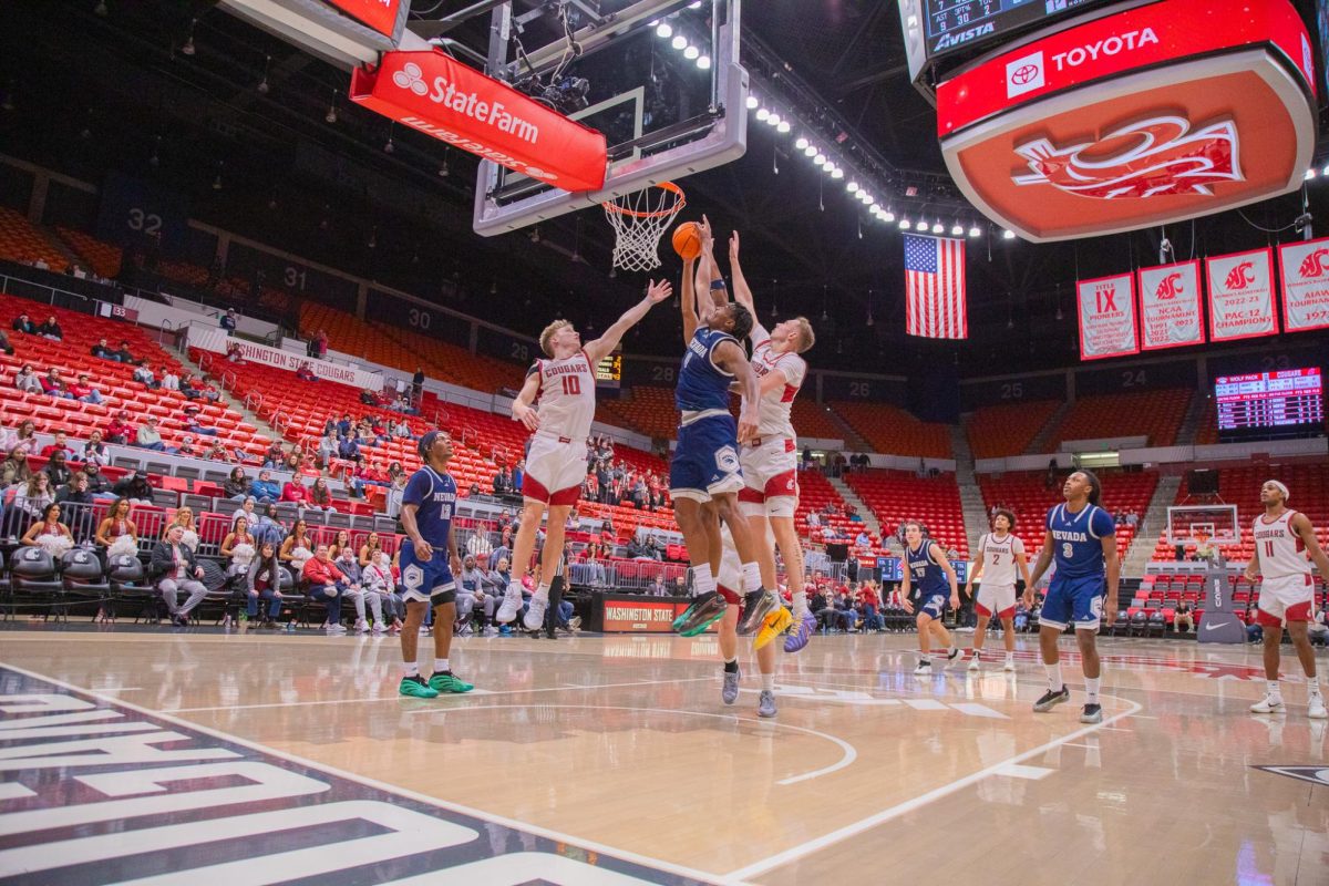 WSU Guard Parker Gerrits and Forward Rihards Vavers block a layup against University of Nevada Guard Chuck Bailey, Dec. 7, 2025