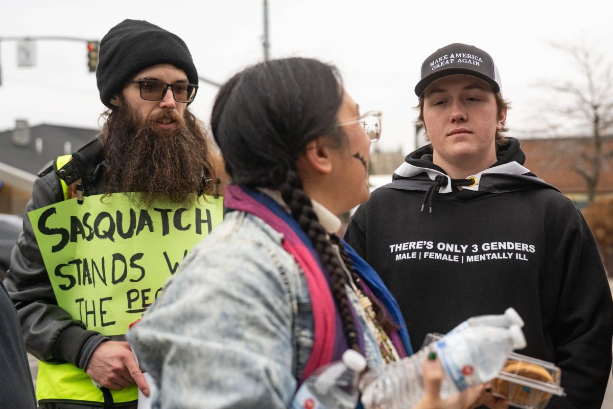 Event organizer and WSU doctorate student Shae Ortega talks with counter protesters during an anti-ICE protest in downtown Pullman on Tuesday, Jan. 20. 