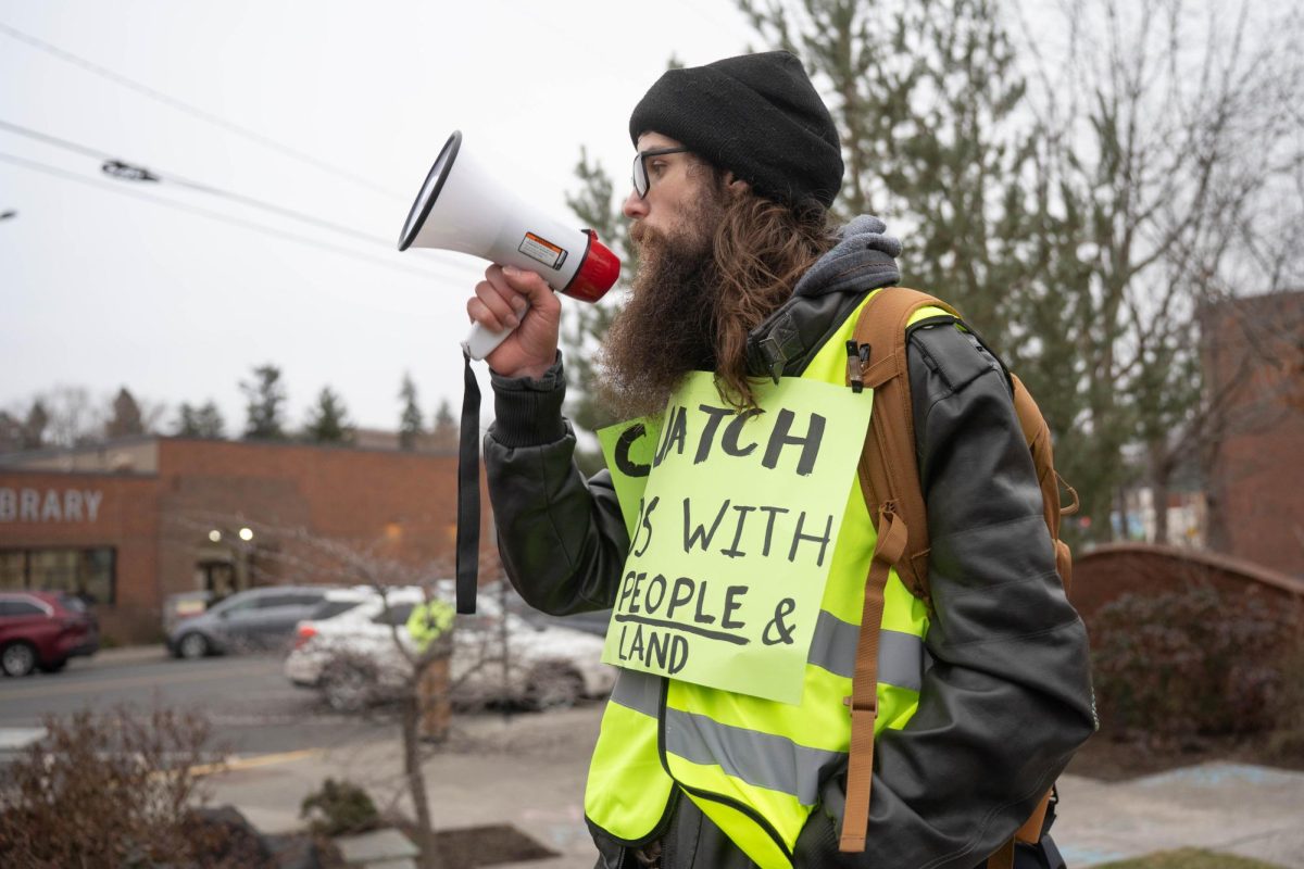 Anti-ICE protesters chant as cars pass by Cougar Plaza in downtown Pullman on Tuesday, Jan 20. 
