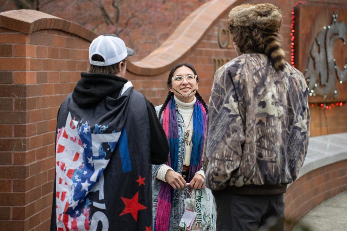 Event organizer and WSU Ph. D. Student Shae Ortega talks with counter protesters during an anti-ICE protest in downtown Pullman on Tuesday, Jan. 20. 