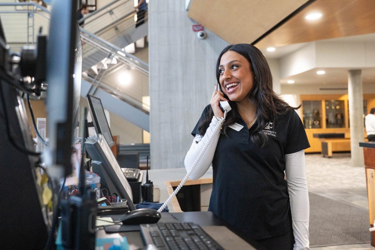 WSU Student Employee Hayley Mitchell answers a phone call at the University Recreation Center on Tuesday, Jan. 13. 
