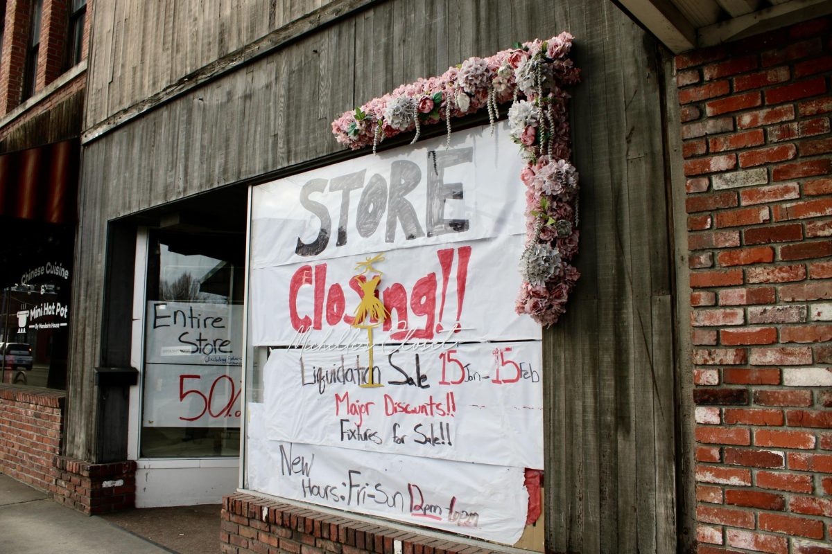 The windows of Michelle's Closet on Grand Ave, covered with notices of closing and liquidation sale. January 28th, 2026, Pullman, WASH