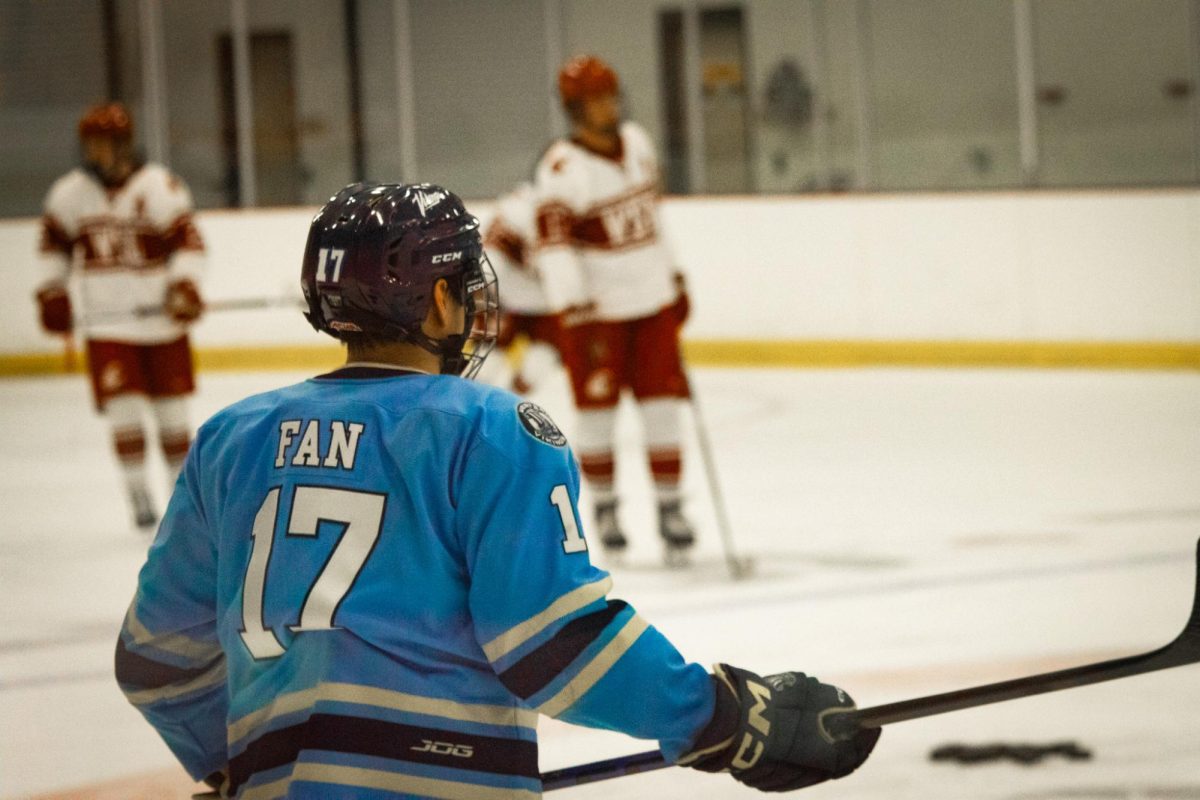 Andrew Fan skates near some WSU hockey players in a game on Jan. 18 2026. 