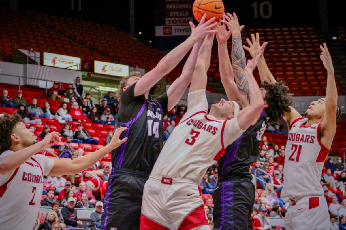 WSU Forward Simon Hildebrandt and Guard Ace Glass reach for the ball against Portland Forwards James O'Donnell and Cameron Williams, Jan. 31, 2026.