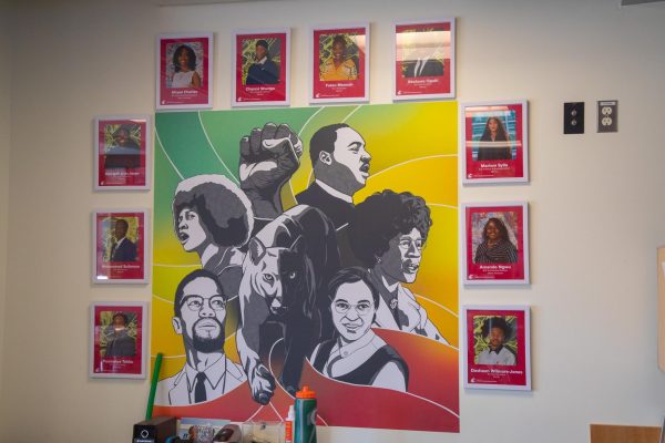 The pictures of BSU's executive council hang around a painting of historic black leaders. 