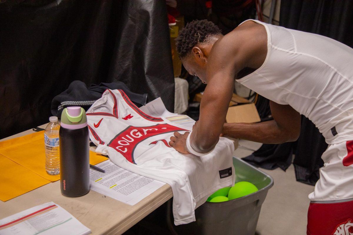 WSU Guard Dio Blakely Signs a jersey for a fan before the game against Saint Mary’s, Feb. 21, 2026.