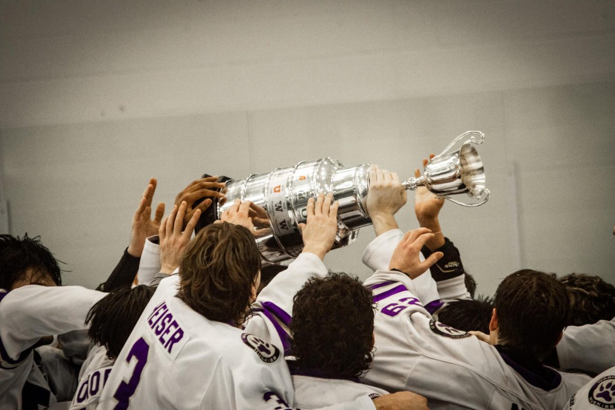 The Husky hockey team hoisting the Pac-8 championship trophy after a 6-3 win over the Cal Berkeley Bears in the 2026 playoffs on Feb. 8 2026.