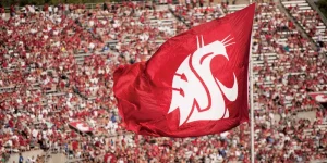 WSU's Ol' Crimson flag being waved during a home football game at Martin Stadium (Courtesy of WSU Athletics). 