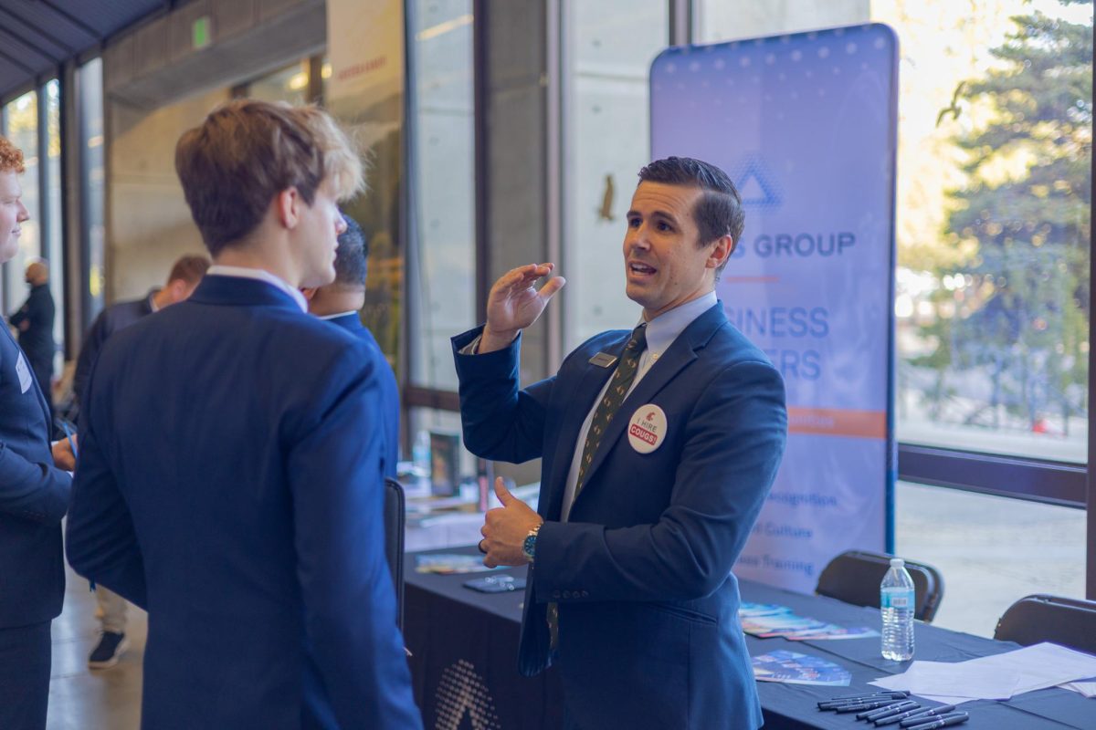Company representatives talking to attendees at WSU's Spring Career Expo at Beasley Coliseum, Feb. 10, 2026.