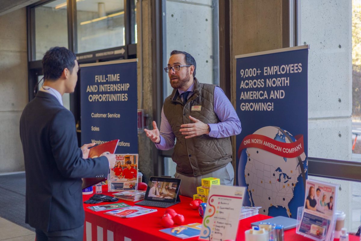 Company representatives talking to attendees at WSU's Spring Career Expo at Beasley Coliseum, Feb. 10, 2026.