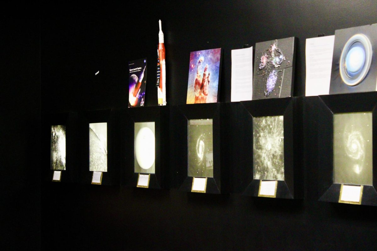 Images and art depicting astronomy and aerospace objects hanging in the WSU Planetarium, March 25, 2026.
