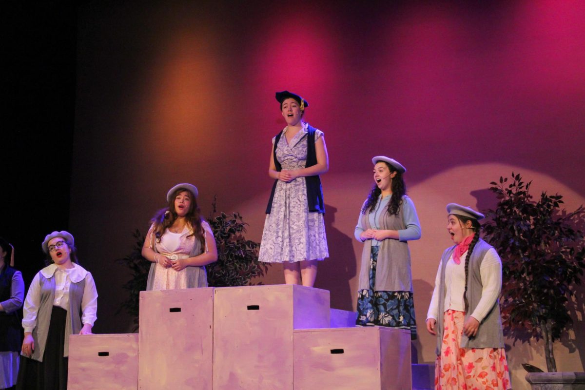(L-R) Zoey Green, Saint Dumandan, Darya Simoneaux, Sophia Stults and Clare Riley sing on a podium during a dress rehearsal for "Princess Ida" at Bryan Hall, March 30, 2026.