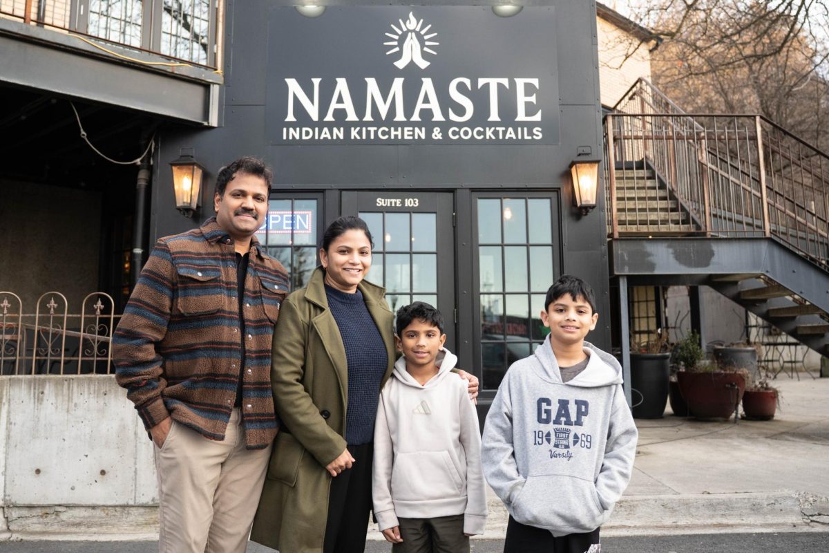 From the left, owners Ravi Chadhu and Suriya Mohan smile for a photo with their sons Aadhad and Adi outside of Namaste Indian Kitchen and Cocktails in downtown Pullman on Friday, Feb. 27. 