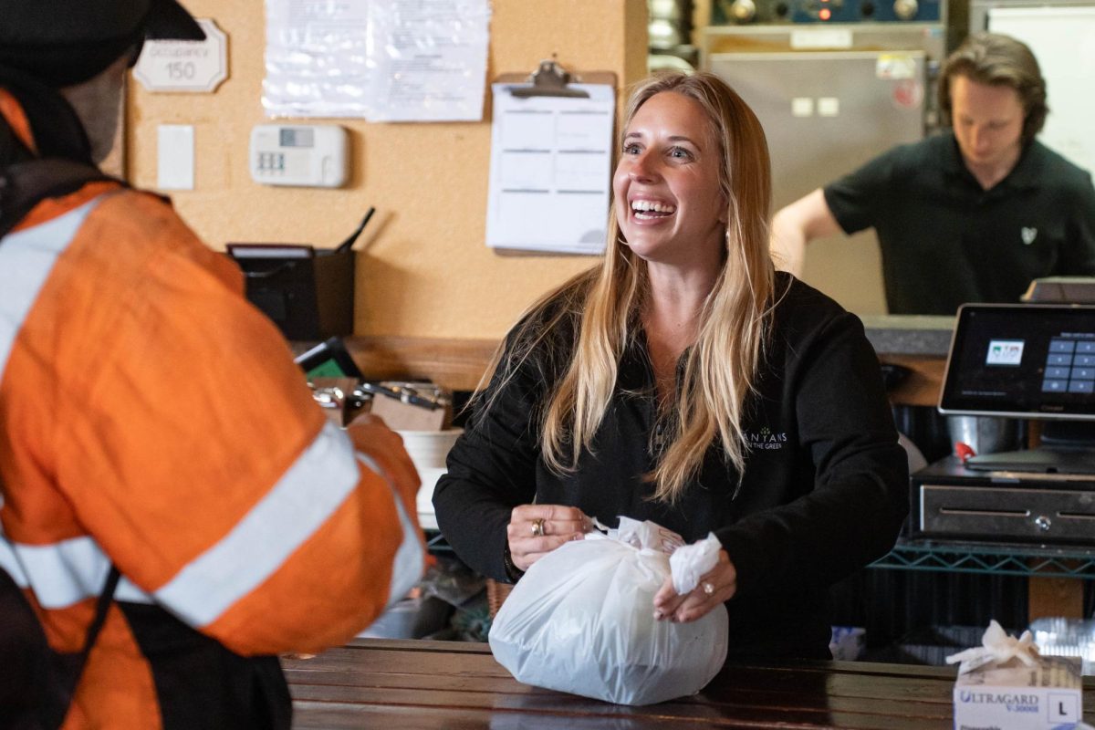 Manager Samantha Holt hands out a free meal during a "Feeding our Friends" event at Scusi Italian Restaurant in downtown Pullman on Tuesday, Apr. 14. 