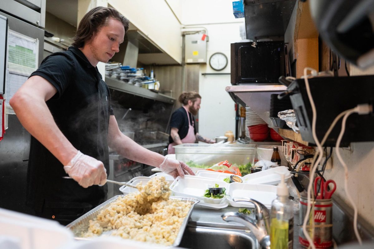 Cook Terry Byrne prepares a free take out dish during a "Feeding our Friends" event at Scusi Italian Restaurant in downtown Pullman on Tuesday, Apr. 14. 