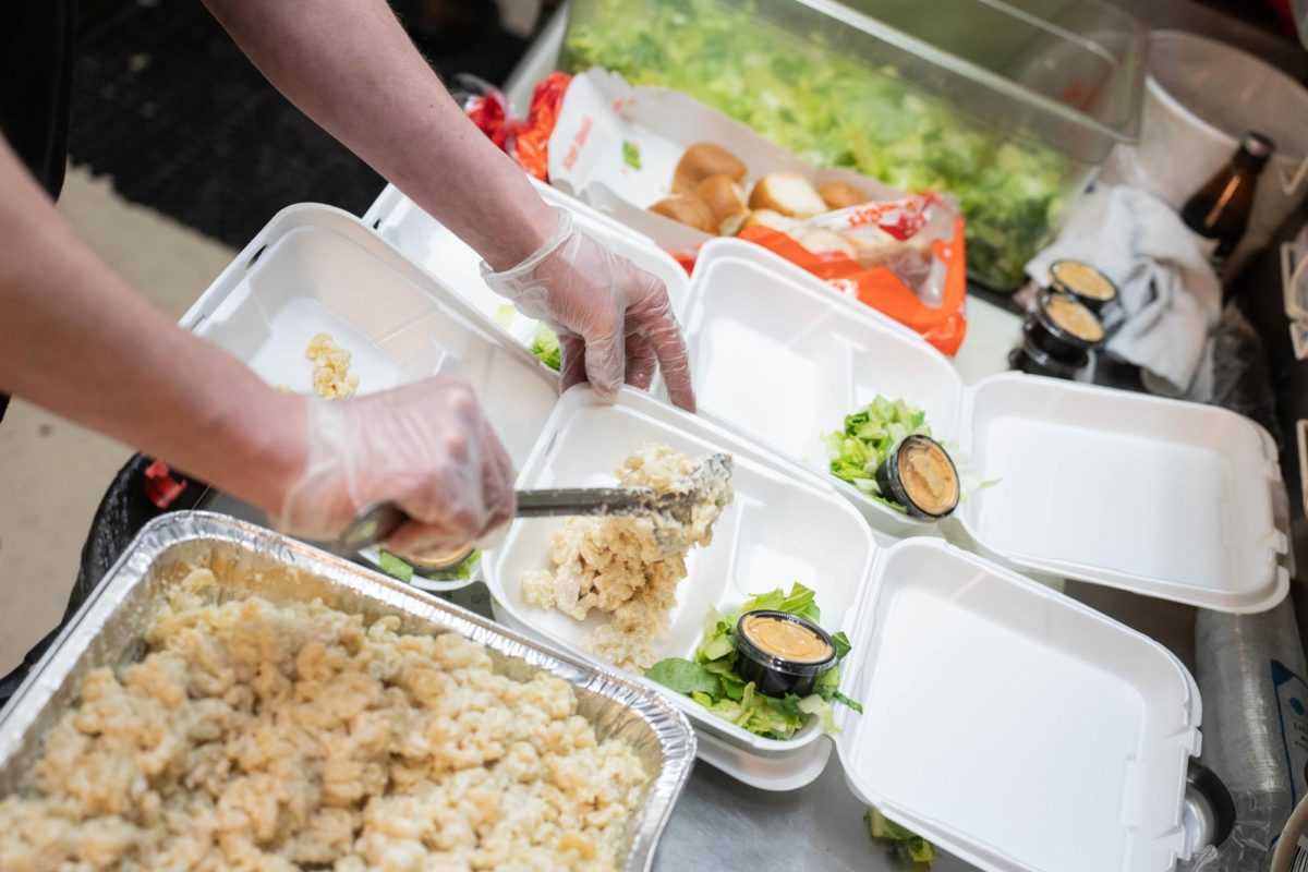 Cook Terry Byrne prepares a free take out dish during a "Feeding our Friends" event at Scusi Italian Restaurant in downtown Pullman on Tuesday, Apr. 14. 