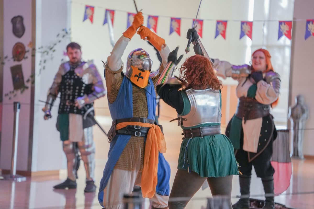 Performers battling in knightly garb at the SEB Re-Coug-Aissance Fair in the CUB, April 17, 2026.