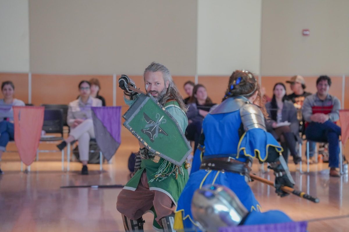 Performers battling in knightly garb at the SEB Re-Coug-Aissance Fair in the CUB, April 17, 2026.