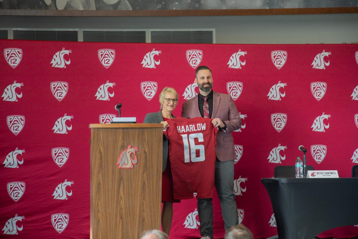 WSU President Elizabeth Cantwell and newly appointed WSU Vice President and Director of Athletics Jon Haarlow hold his commemorative jersey at the announcement press conference, April 20, 2026.