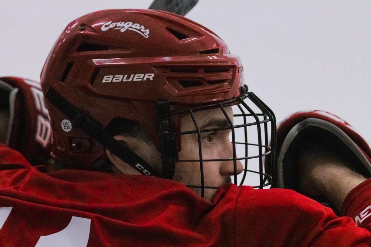 Former Coug hockey player Luke Juergensen stares out at the ice during WSU hockey's prospect camp. 