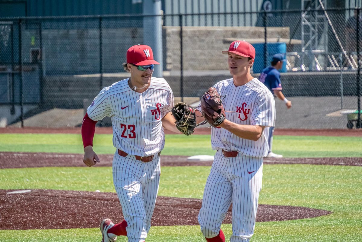 WSU Right-fielder Max Hartman (23) and Pitcher Luke Meyers (32) celebrating the end of an inning against Fresno State University baseball, May 3, 2026.
